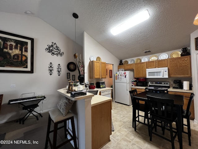 kitchen featuring kitchen peninsula, a breakfast bar, white appliances, pendant lighting, and lofted ceiling