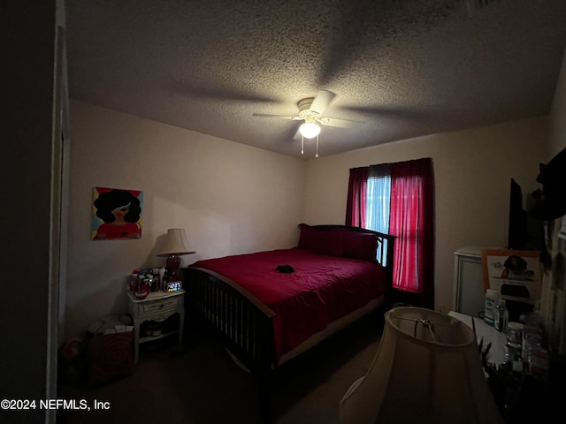 bedroom featuring ceiling fan and a textured ceiling