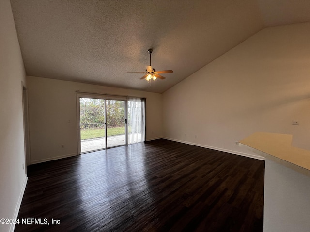 spare room with a textured ceiling, dark hardwood / wood-style flooring, ceiling fan, and lofted ceiling