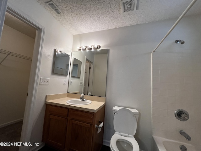 full bathroom featuring vanity,  shower combination, toilet, and a textured ceiling