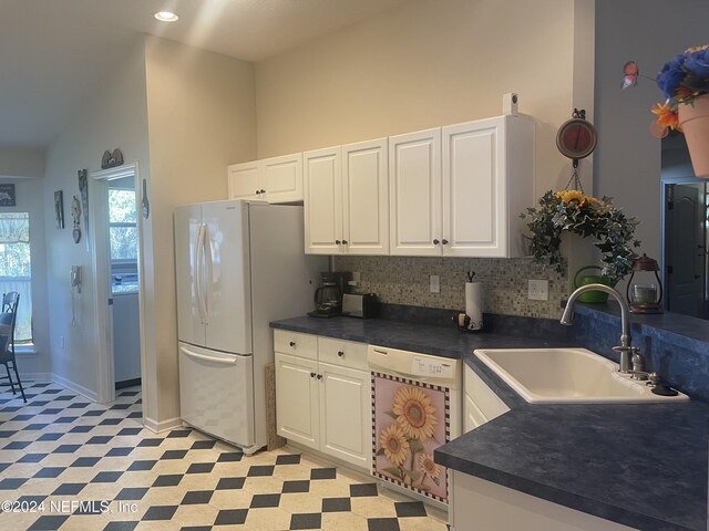 kitchen with white cabinetry, sink, backsplash, vaulted ceiling, and white appliances