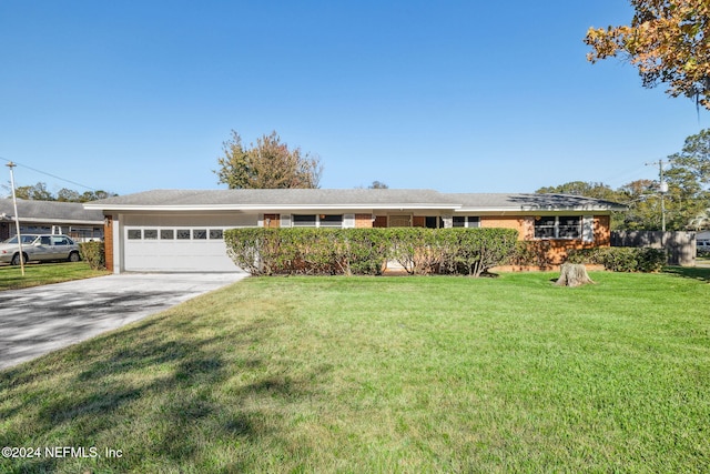 ranch-style house with a garage and a front lawn