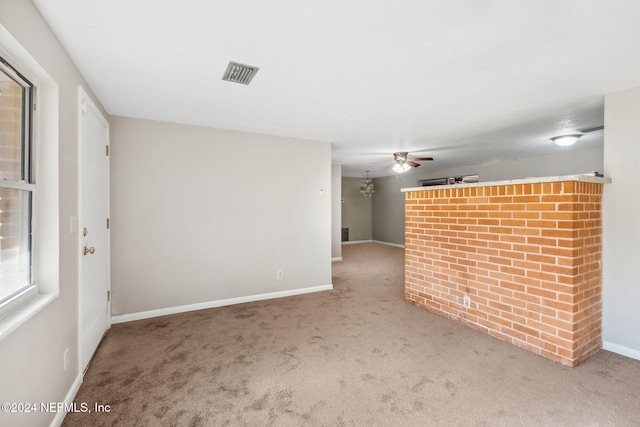 unfurnished room with carpet and ceiling fan