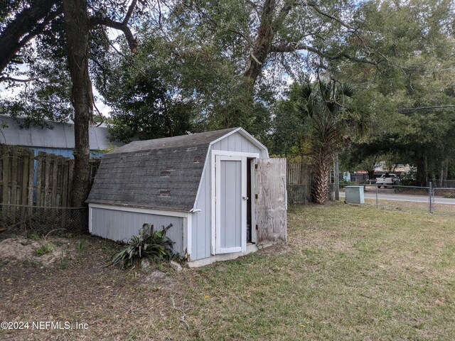 view of outbuilding with a lawn