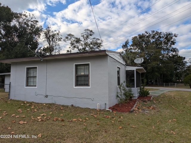 view of property exterior with a lawn