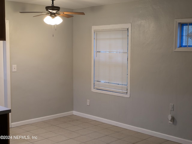 spare room featuring ceiling fan and light tile patterned floors