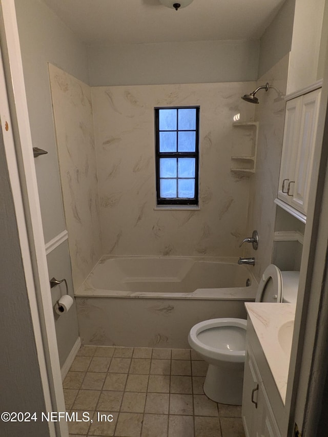 full bathroom featuring tile patterned flooring, toilet, vanity, and tiled shower / bath