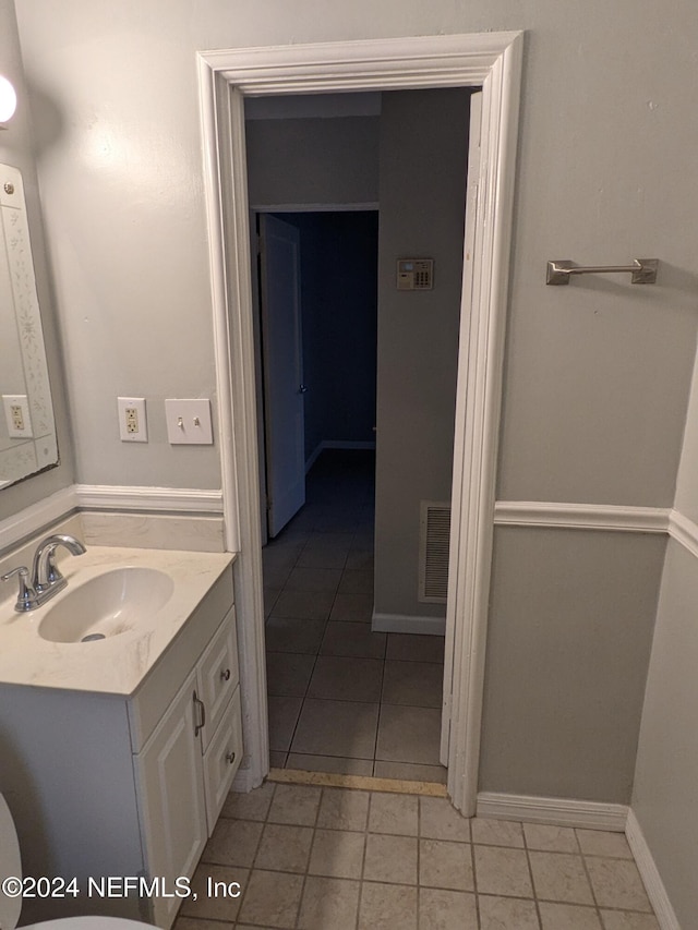 bathroom with tile patterned floors, vanity, and toilet