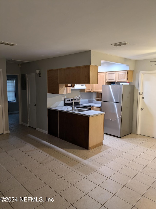 kitchen featuring light brown cabinets, light tile patterned flooring, kitchen peninsula, stainless steel appliances, and extractor fan