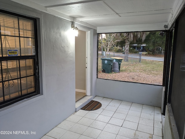 unfurnished sunroom featuring a wealth of natural light