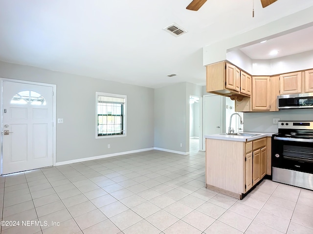 kitchen with sink, ceiling fan, light tile patterned floors, light brown cabinetry, and appliances with stainless steel finishes