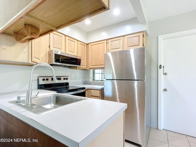 kitchen featuring kitchen peninsula, light brown cabinetry, stainless steel appliances, sink, and light tile patterned floors