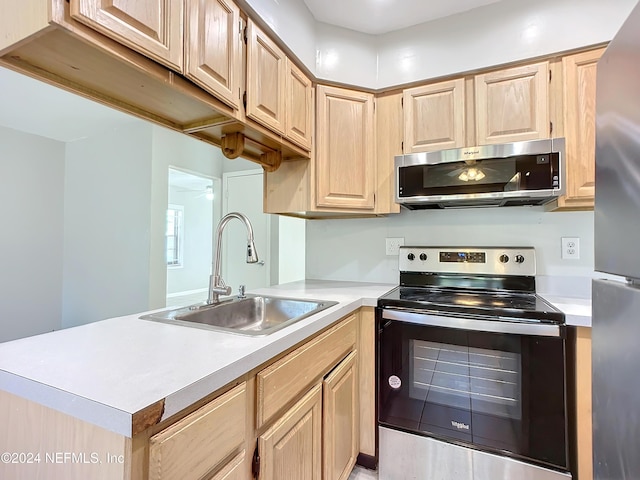 kitchen with ceiling fan, sink, light brown cabinets, kitchen peninsula, and appliances with stainless steel finishes