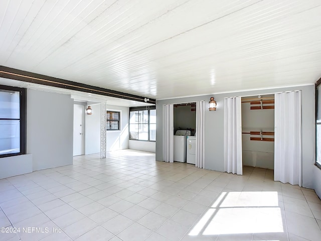 empty room featuring washer and clothes dryer and light tile patterned floors