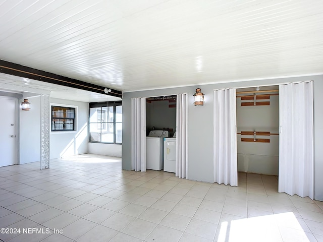 empty room featuring independent washer and dryer and light tile patterned floors