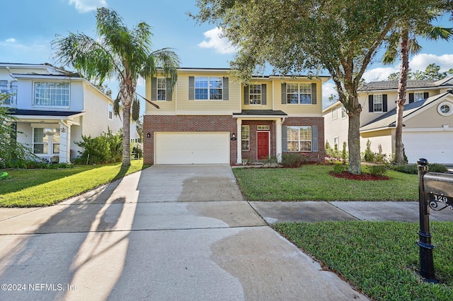 view of front of property featuring a front yard and a garage