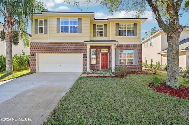 view of front of home featuring a front yard and a garage