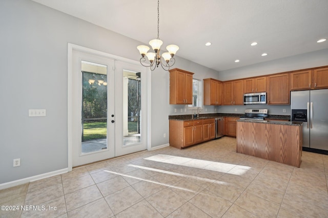 kitchen with sink, plenty of natural light, a kitchen island, and appliances with stainless steel finishes