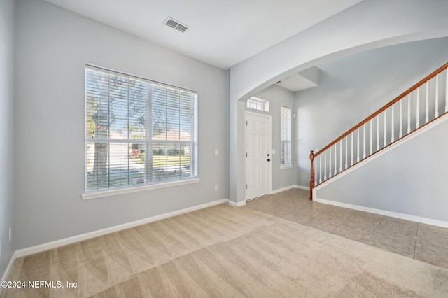 entryway featuring light colored carpet