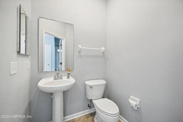 bathroom featuring tile patterned floors, toilet, and sink