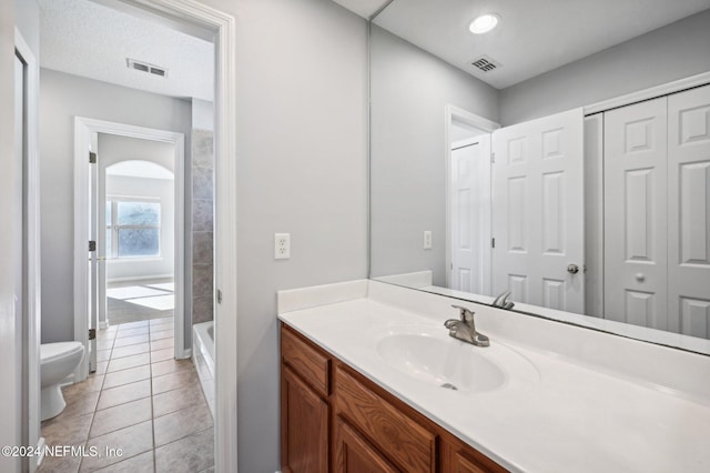 full bathroom with tile patterned floors, shower / bathing tub combination, vanity, and toilet