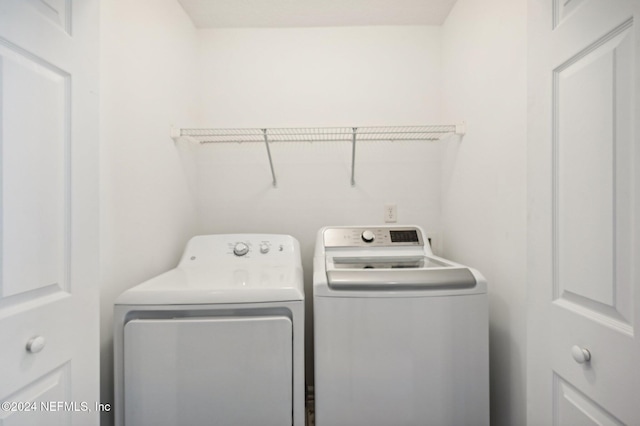 clothes washing area with separate washer and dryer