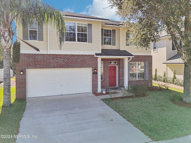 view of front facade with a front yard and a garage