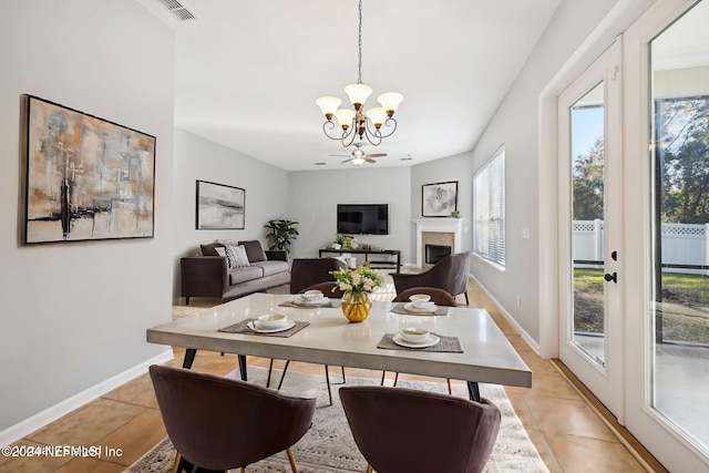 tiled dining room featuring a notable chandelier