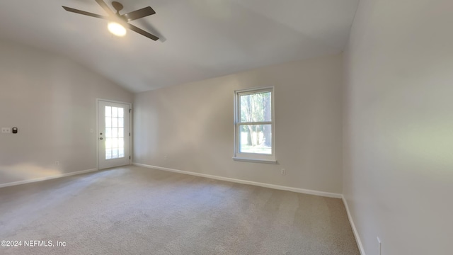 unfurnished room with lofted ceiling, a wealth of natural light, light carpet, and ceiling fan