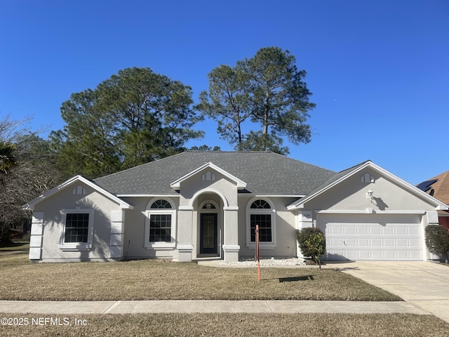 ranch-style home with a garage and a front yard