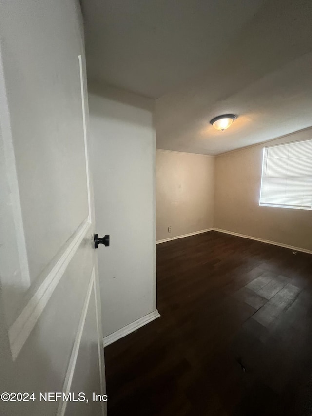 empty room featuring dark wood-type flooring