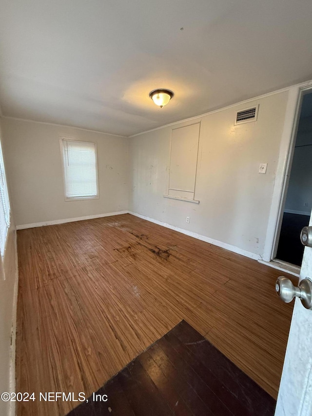 unfurnished room with wood-type flooring