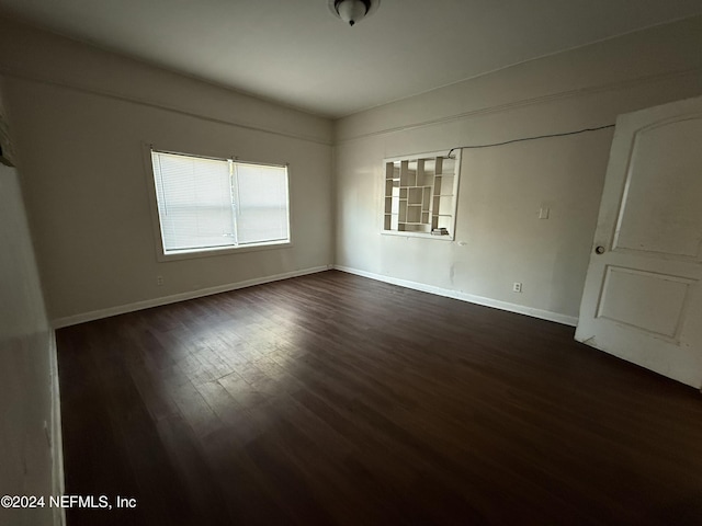 empty room with dark wood-type flooring