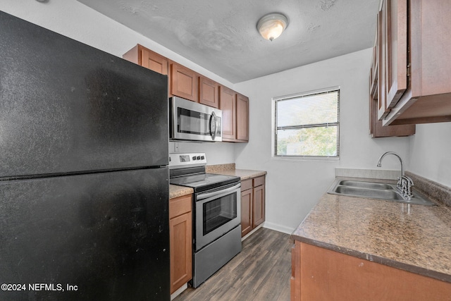 kitchen with dark hardwood / wood-style floors, sink, and appliances with stainless steel finishes