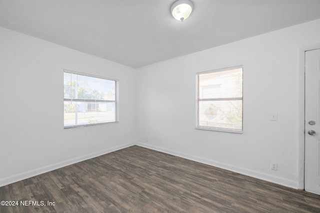 empty room with dark hardwood / wood-style floors