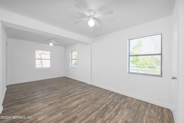 spare room featuring ceiling fan and dark hardwood / wood-style flooring