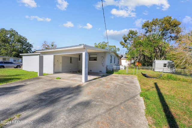 view of front of house with a front yard and a carport