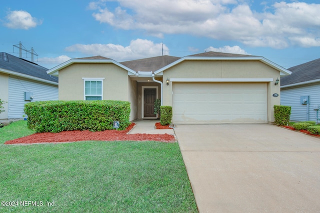 single story home featuring a garage and a front lawn