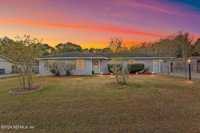 ranch-style house featuring a yard