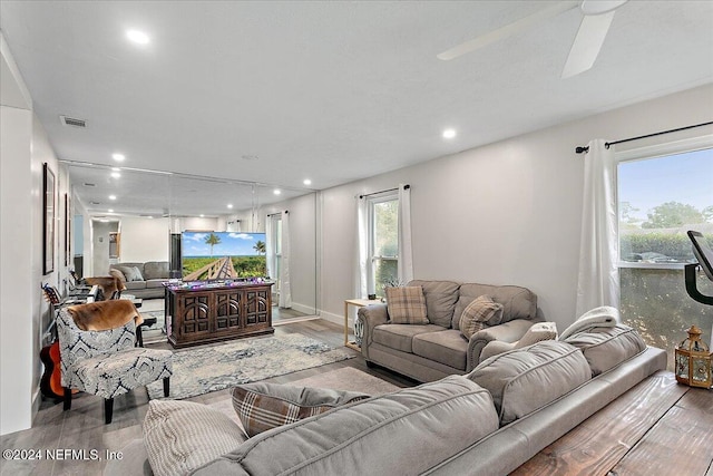 living room featuring hardwood / wood-style flooring and ceiling fan