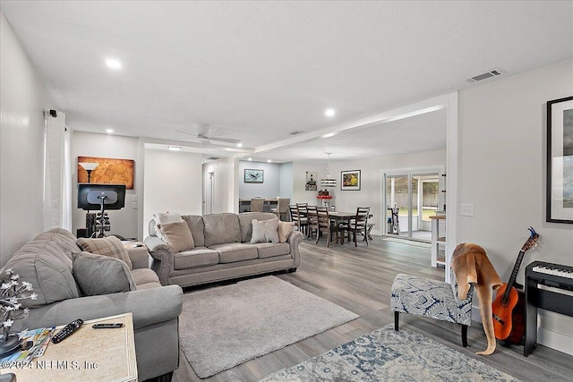 living room featuring ceiling fan and light wood-type flooring