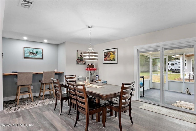 dining space with hardwood / wood-style floors