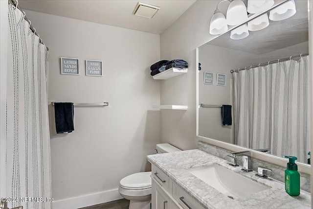 bathroom featuring hardwood / wood-style floors, vanity, and toilet