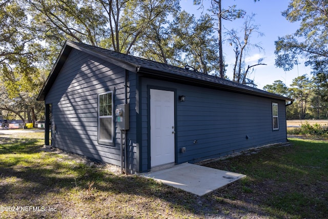 view of outbuilding featuring a yard