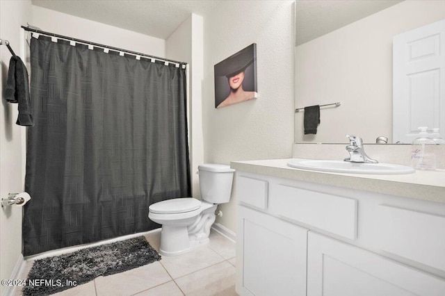 bathroom featuring tile patterned flooring, vanity, and toilet