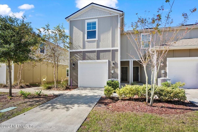 view of front of house featuring central AC unit and a garage