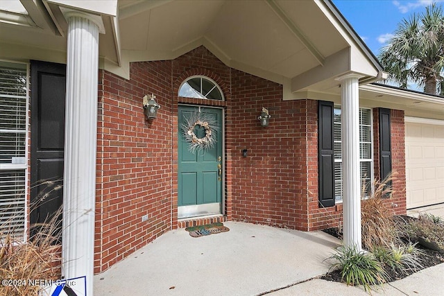 doorway to property with a garage