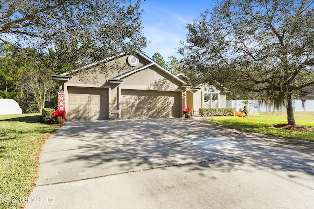 single story home with a front yard and a garage