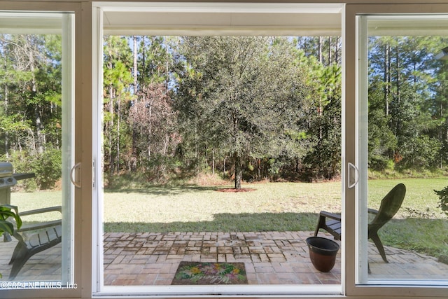 35 Sunlight Way, Saint Augustine, FL 32092 - doorway to outside featuring view of wooded area and brick flooring