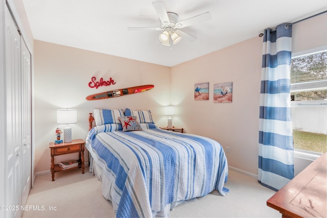 carpeted bedroom with ceiling fan and a closet